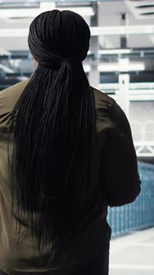 Vertical Video Woman Walking Through Data Center Server Rows Checking Equipment