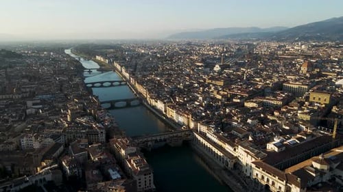 Aerial view of historic cityscape and Arno River, Italy.