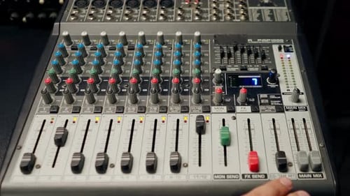 close-up of control buttons of a mixing console for recording soundtrack in a recording studio