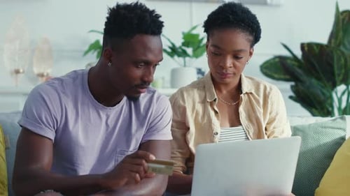 Couple Shopping Online with Credit Card at Home