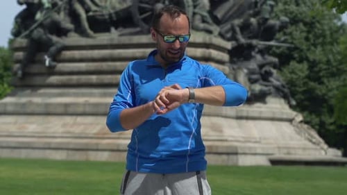 Man Setting Smartwatch for Distance and Start Jogging in City Park, Super