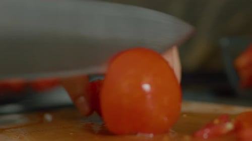 Tomato Sliced on Cutting Board with Sharp Knife