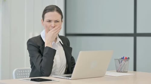 Sick Woman Coughing at Work on Computer