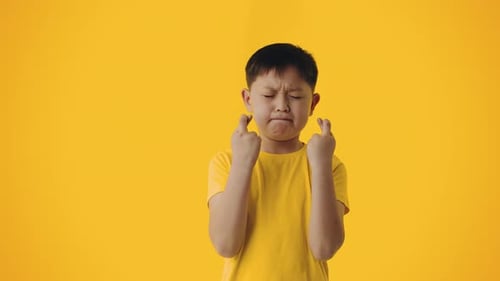 Boy Crossing Fingers, Wishing with Closed Eyes