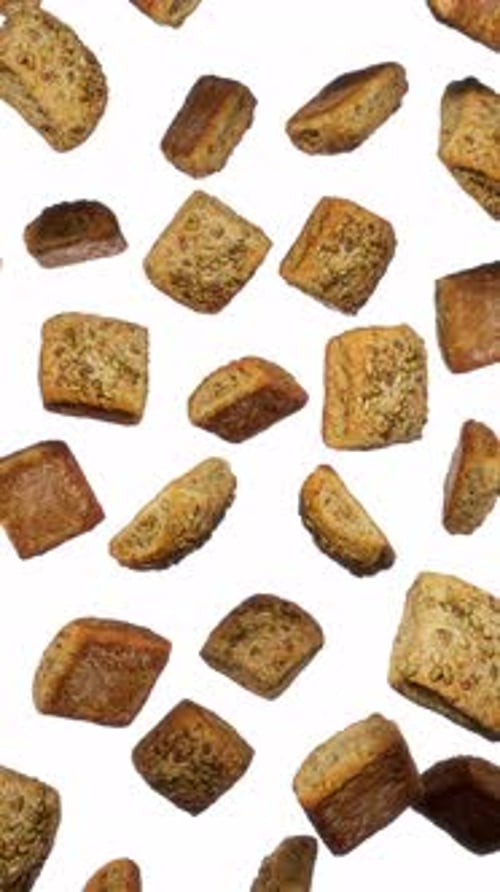 Falling Baked Goods and Croutons on White Background