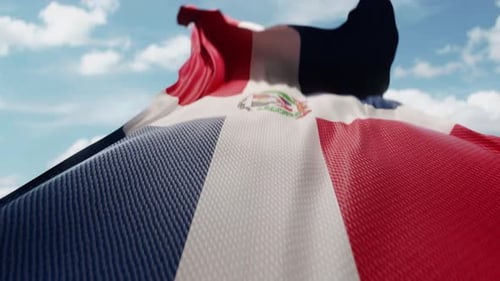 Dominican Republic Flag Waving in a Clear Blue Sky