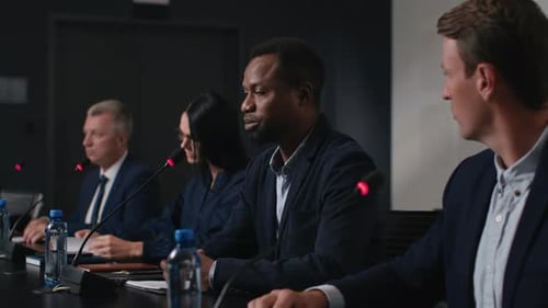 Adult black man delivers powerful speech at business forum in convention hall