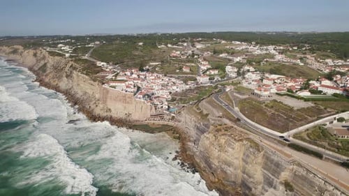 Long strong waves crash on coastal rocks and cliffs, Azenhas do Mar, Portugal