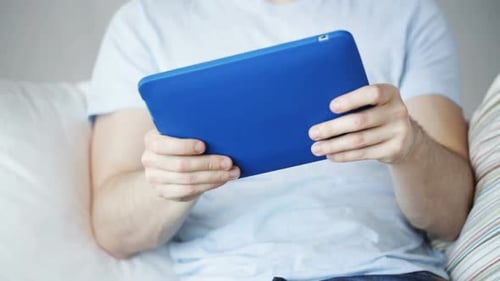 Technology, Lifestyle and People Concept - Close Up of Man Playing Game