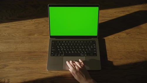 Hand Touching Laptop Trackpad with Green Screen Display