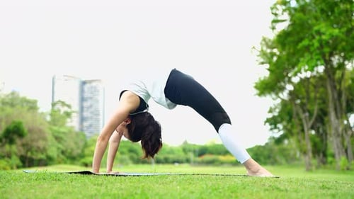 Woman Practicing Yoga in Park