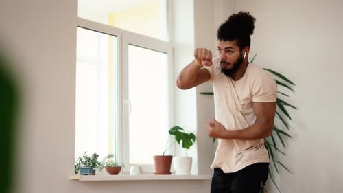 Slow Motion of Goodlooking Mixed Race Man Training in Active Boxing Punches During Home Workout Slow