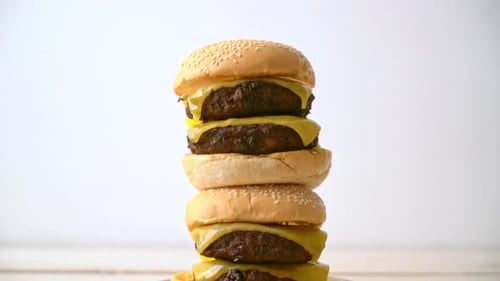 Stacked Cheeseburgers with French Fries Rotating Close Up