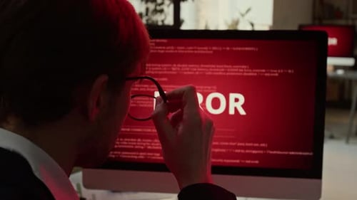 Man Reacts to Error Message on Computer Screen