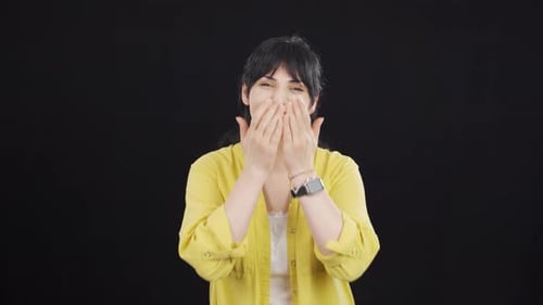 Woman Smiling and Gesturing in Studio Setting