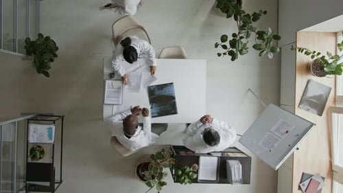 Time Lapse of Doctors Discussing Patient Cases and Studying Paperwork in Office