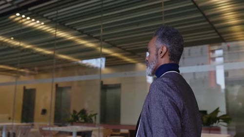 Senior Adult African American Man Walking Outside Office Buildings