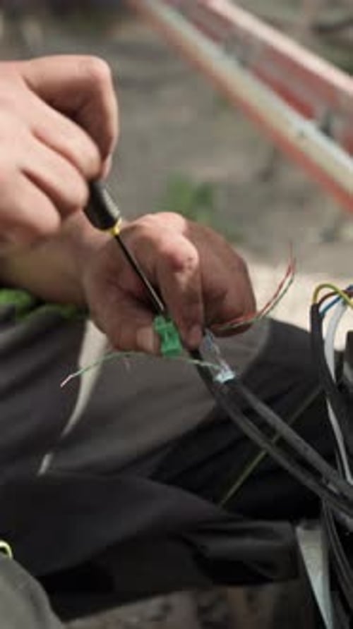 Hands Working with Electrical Wires