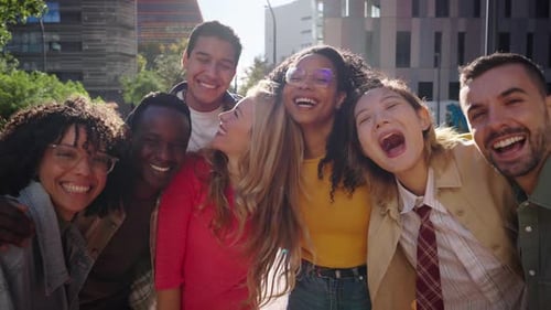 Laughing Group of Young Diverse Friends Looking Joyful at Camera Having Fun Together at City Street