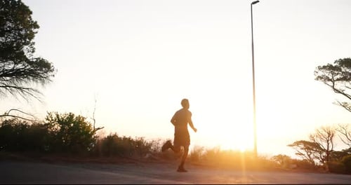 Man, fitness and running with sunset on mountain road for workout, cardio exercise