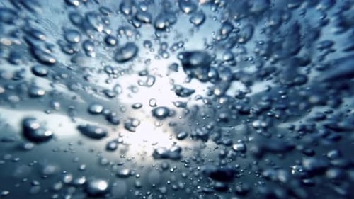 Slow motion, featuring air bubbles rising elegantly from the sea bottom to the water's surface