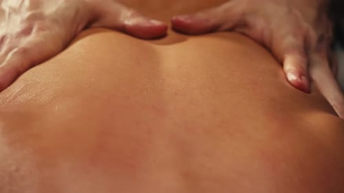 Hands Massage Back with Oil Close Up