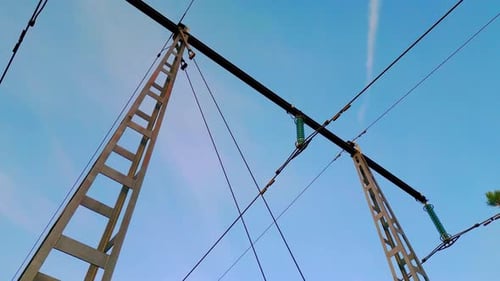Power line transmission tower close up. DOLLY OUT TILT DOWN SHOT.