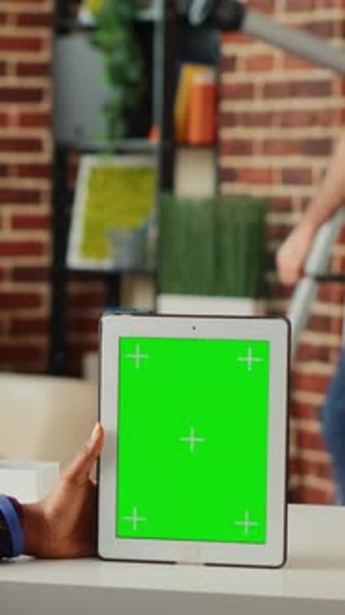 Tablet with Green Screen on a Desk Indoors