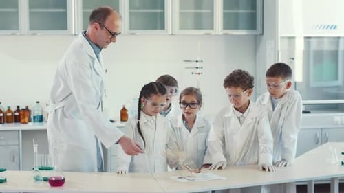 Children Doing Science Experiment with Teacher in Lab