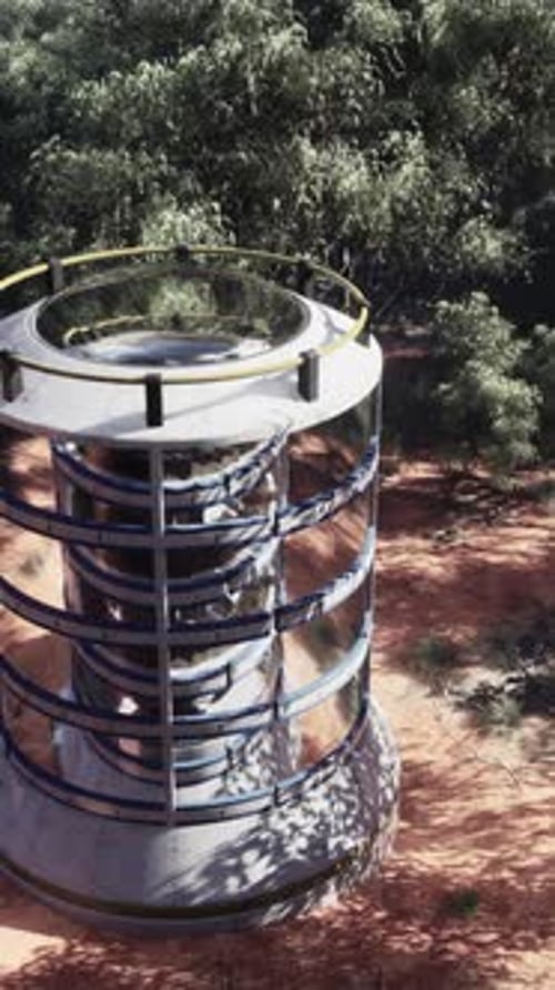 A Futuristic Glass Greenhouse Tower in the Middle of a Lush Forest