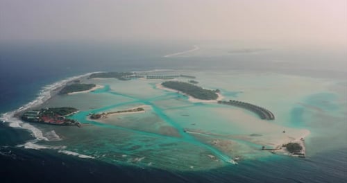 Aerial view of a scenic landscape of desert island with white sand beach and crystal clear sea wat