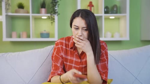 Worried Woman Reacting to News on Mobile Phone
