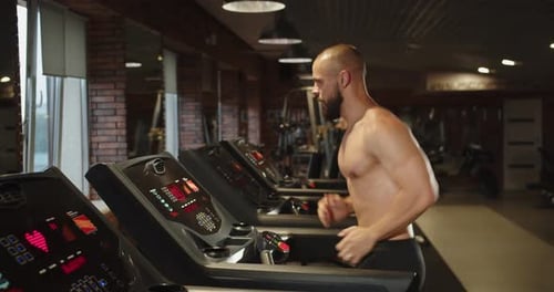 Experienced Athlete is Improving His Body Doing Cardio on Treadmill in the Gym
