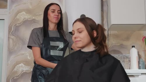 Customer Reclines Comfortably As Hairdresser Provides Relaxing Wash Ritual Indulging in Peaceful