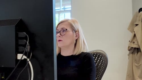 Professional Adult Woman Working In Front Of Desktop Computer In Office. medium shot