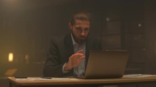 Man Working Late on Laptop in Office