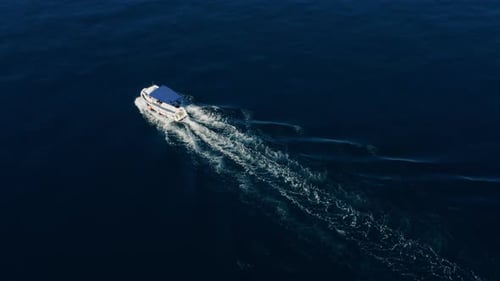 Small Motor Fishing Boat Leaving Wake On A Calm Sea Of Adriatic In Croatia. - aerial