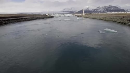 Aerial view of Jokulsarlon glacier lagoon with iceberg floating and mountains