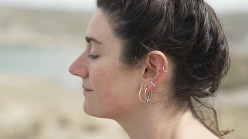 Woman with Ear Piercings Relaxing with Eyes Closed Focus Shot