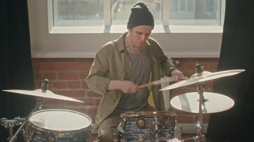 Young Man Playing Drums Indoors