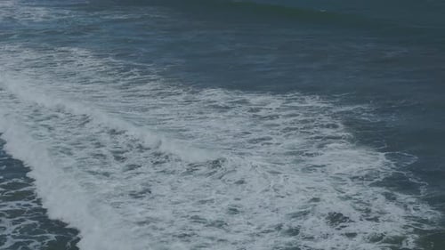 Aerial View of Powerful Surf Along Bali Coastline with Blue Ocean and Reef