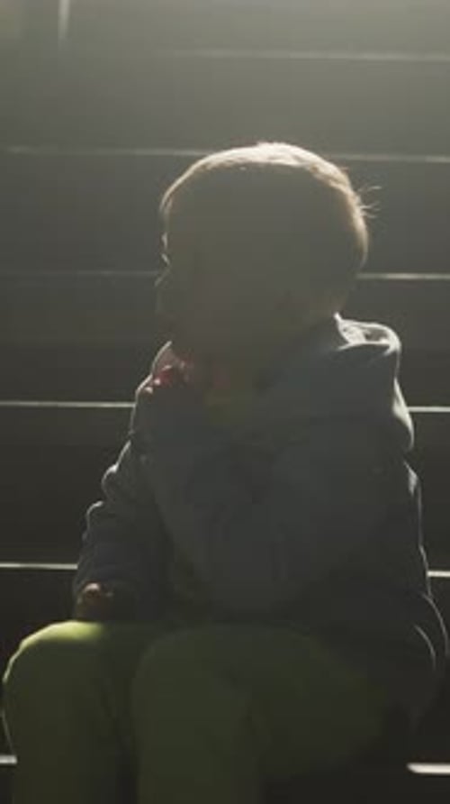 Child Sits on Stairs Contemplating