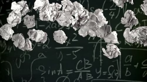 Crumpled Paper Rises and Falls Against the Background of the Blackboard Filmed on a Highspeed Camera