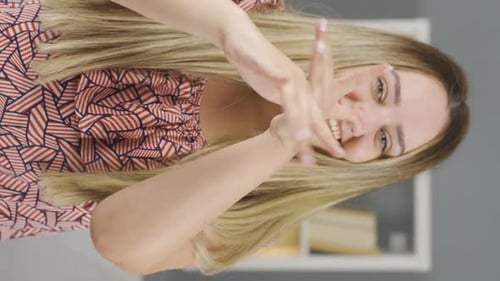 Woman Applies Lotion to Her Hands and Smiles