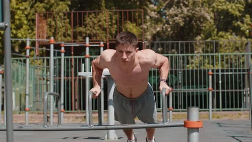Man Doing Push-ups in Urban Outdoor Gym