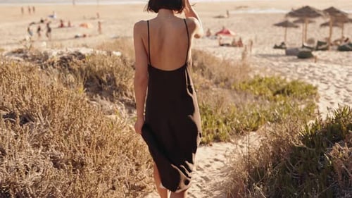 Woman Walking On Beach Sand