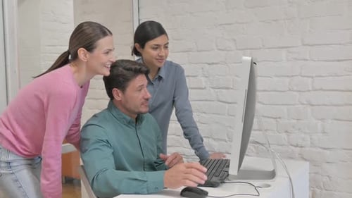 Team Collaborating with Technology in Modern Office