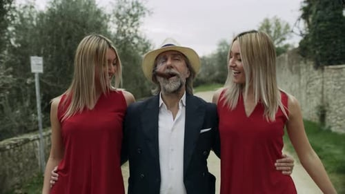 Content Older Italian Man Smoking Cigar Walking with Younger Identical Twin Sisters
