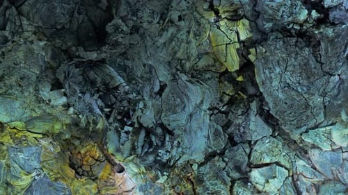 Top down of solid basalt lava field with different colored surface minerals