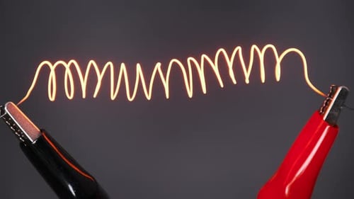 Wire Glowing with Electricity between Alligator Clips